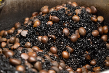 The process of roasting chestnuts with hot stones