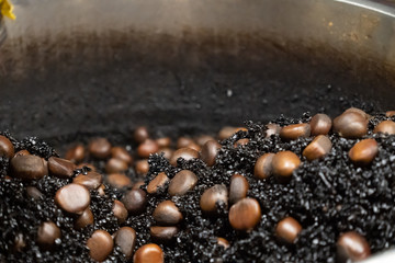 The process of roasting chestnuts with hot stones