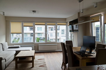 Part of a newly renovated living room with TV, table, chairs, laptop computer, mobile telephone and headset, Sofia, Bulgaria, Europe 