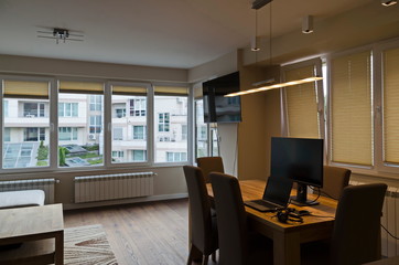 Part of a newly renovated living room with TV, table, chairs, laptop computer, mobile telephone and headset, Sofia, Bulgaria, Europe 