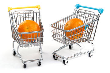 A mandarin in shopping cart isolated on white background. Ripe tasty tangerines in shopping cart....