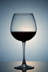 Glass of red wine poured