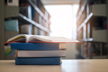 Open book on wood desk in library.