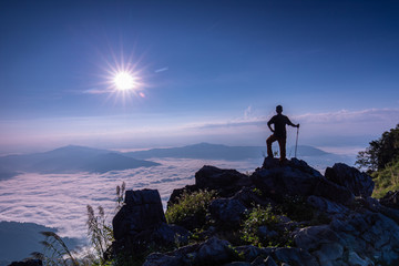 The man hiking on Doy-pha-tang, Landscape sea of mist on Mekong river in border  of  Thailand and Laos.