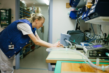 Female engineer checking hospital equipment