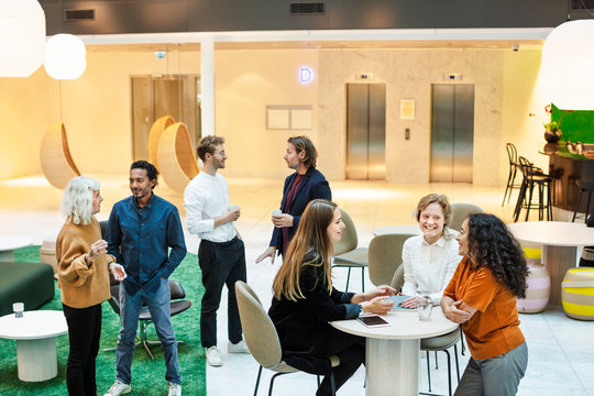 Coworkers in business team working together in open plan office