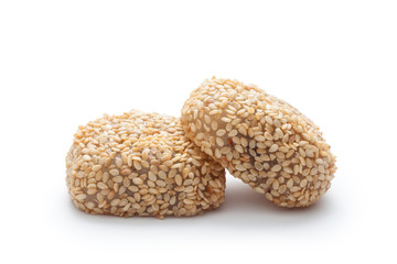 Glutinous rice balls stuffed with white sesame and sugar on white backgroudn. Chinese traditional cuisine, pastries.