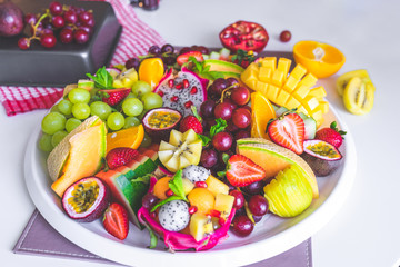 close up large tray of sliced assorted fresh tropical fruits platter