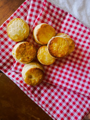 Top view of Fresh Homemade delicious butter scones on red cloth . Traditional British Scones perfect combination for tea time.