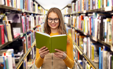 high school, education and knowledge concept - smiling teenage student girl in glasses reading book over grey background