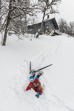 Fallen skier lying in powder snow