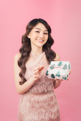 beautiful young asian woman holding present
