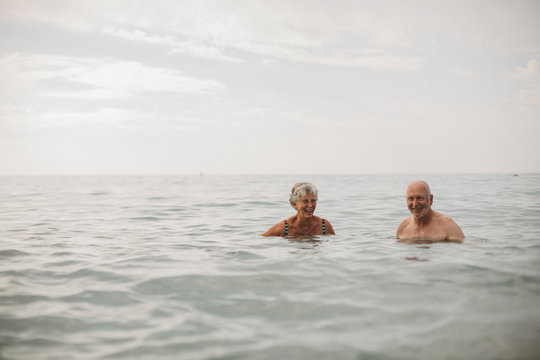 Senior couple bathing in sea