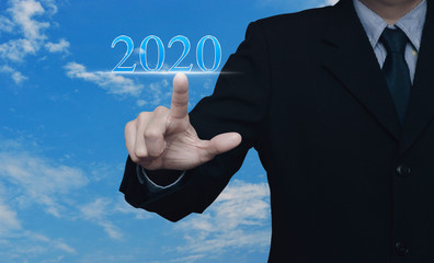 Businessman pressing 2020 text over blue sky with white clouds, Happy new year 2020 calendar cover concept