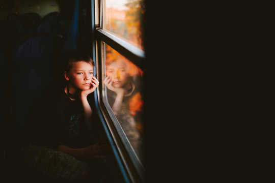 Boy looking through train window