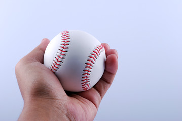 A hand holding the baseball.