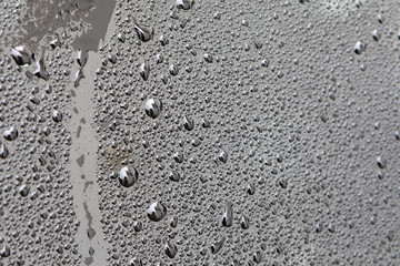 Grey surface with drops of rain water
