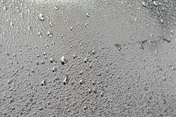 Grey surface with drops of rain water