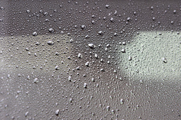 Grey surface with drops of rain water