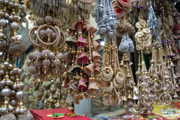 Colorful metallic decorations on display for sale in Chandi Chowk Old Delhi. These flowers, beads and bells designs are popular in weddings, festivals and events.