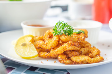 Crispy onion rings served on a white plate