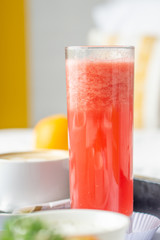 Watermelon juice is served on slim clear glass.