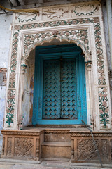 Fototapeta na wymiar Decorative doorway and doorframe, with plants, in Old Delhi India near Chandi Chowk road