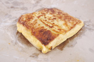 Close up of murtabak on paper parchment