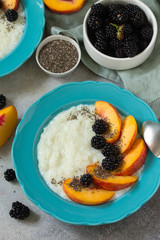 Healthy and vitamin breakfast. Oatmeal with chia, nectarines and blueberries on a stone countertop.