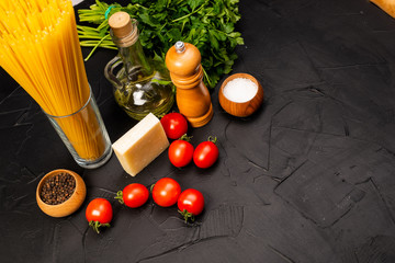 Concept of Italian food. Pasta, tomato, olive oil, pepper, parsley and cheese. Selective focus. Top view
