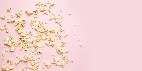 Tasty salty or sweet popcorn border on pink background with copy space. Watching movie, cinema, concept.