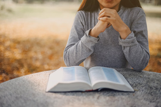 Woman reading and praying over Bible