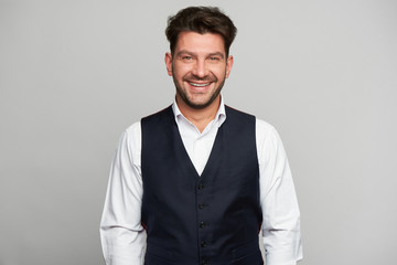 Happy young bearded guy looking at camera