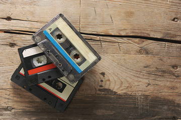 Old audio tape compact cassettes on wooden background