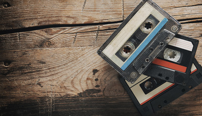 Old audio tape compact cassettes on wooden background