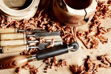 Woodworkers shop. Woodturning project. Making handmade wooden bowls.  Carpenters chisels and...
