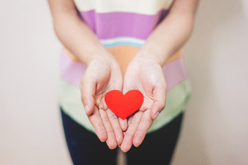 Soft focus Hand giving a red heart 