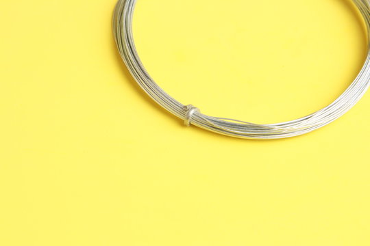 roll of metal wire of hardware store on colored background