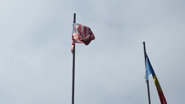 American flag waving in the wind against the sky.