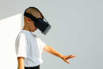 Children experiencing virtual reality isolated on white background. Surprised little boy looking in VR glasses.