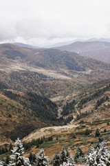 Fototapeta premium The first snow in the Ukrainian mountains, clouds low mountains