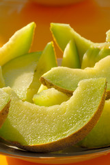 Slices of melon lie on the table.
