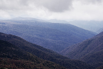 Fototapeta premium The first snow in the Ukrainian mountains, clouds low mountains