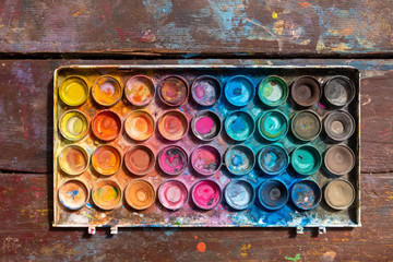 Used large watercolor palette on old wooden table - top view © Greg Brave