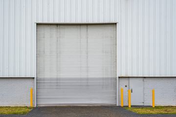 Obraz na płótnie Canvas Large warehouse closed white rolling door with copy space