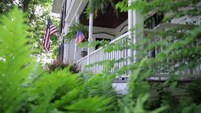 Flower garden and front porch of a beautiful federal style building.