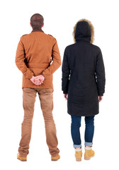 Back view of couple in winter jacket.