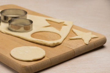 Dough for baking ginger cookies on a cutting board,  form for cutting cookies