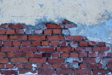 A dirty smudged red brick wall with the old paint