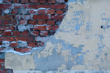 A dirty smudged red brick wall with the old paint